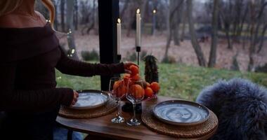 A woman relaxes at a table with fruit and wine, enjoying serenity video