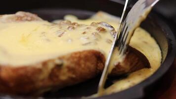 A close-up shot showcasing warm french toast slices generously smothered in melted cheese, oozing with flavor, prepared for a hearty meal. video