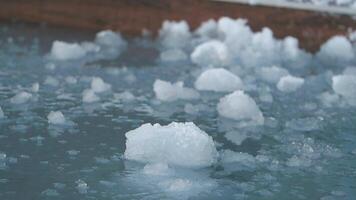 Ice formations create unique patterns on tranquil water surface video