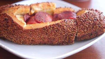 Savory bread topped with sausage and cheese from local bakery video