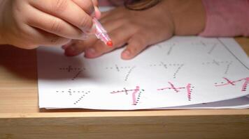 Child learning to write using a marker on paper at home video