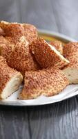 Freshly baked simit rolls with sesame on a rustic plate video