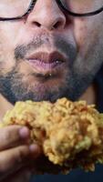 Enjoying crispy fried chicken with a big bite at a local eatery video