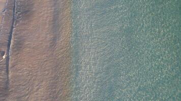 aerial ascending top down view footage by drone of clean seawater in the shore of a beach, texture summer concept background video