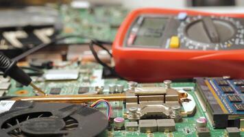 Close-Up of Circuit Board Testing with Multimeter Probes, Gloved hands using multimeter probes to test components on a computer motherboard. video