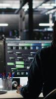 Vertical Irked data center IT expert smashing desk, upset by malfunctioning gear while using node tree software. Mad server hub engineer disgruntled by errors, using glitching AI visualization tech, camera B video