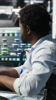 Vertical Man in wheelchair dissatisfied with server farm AI analytics metrics. Data center admin with paraplegia frustrated by glitches while automating tasks using node tree programming tool, camera B video