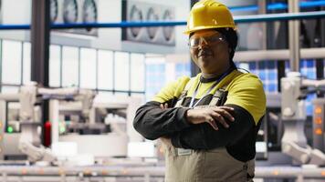 Portrait of jolly smart factory engineer calibrating high tech machinery and analyzing sensor data. Happy industrial plant worker troubleshooting assembly equipment, camera B video