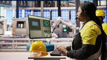 Call center agent in smart factory using headset to assist remotely with maintenance queries, monitoring automated solar panel assembly processes, providing technical guidance, camera A video