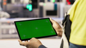 Smart factory expert uses green screen tablet to implement automated workflows. Industry 4.0 plant technician integrates sensors into production using chroma key device, camera B close up video