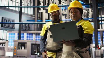 Engineering team working together, overseeing solar panel production lines equipment. Teamworking colleagues maintaining photovoltaic assembly systems in automated industry 4.0 factory, camera A video