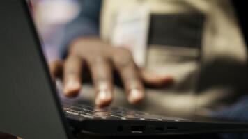 Close up of smart factory worker using laptop to test automated systems, monitoring production metrics. Industry 4.0 plant expert inspecting machinery to identify and fix malfunctions, camera B video