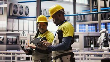 Smart factory engineering team brainstorming ways to implement automated workflows and control systems. Industry 4.0 plant teamworking colleagues integrates sensors into production, camera A video