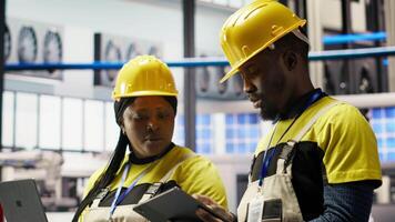 Smart factory engineering team brainstorming ways to implement automated workflows and control systems. Industry 4.0 plant teamworking colleagues integrates sensors into production, camera B video