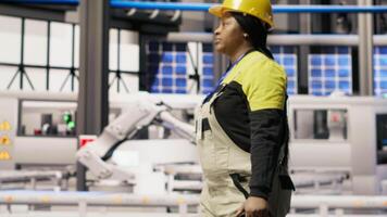 Smart factory mechanic installing automated workflows control systems, computerizing operations. Repairman walking in industry 4.0 plant with toolbox, integrating sensors into production, camera B video