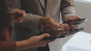 Two people holding a tablet computer and a smartphone video