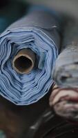 Stacks of folded fabric rolls in textile workshop video