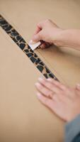 Tailor marking leopard fabric with chalk and ruler video