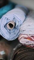 Stack of multicolored fabric rolls in textile storage video
