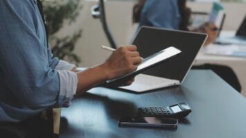 A man is using a tablet while sitting at a desk video