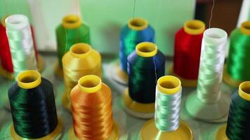 Threads in spools for dressmaker. Collection of colorful threads. Sewing tools. Background of colorful bobbins. Close-up. Hobbies and handicraft concept. video
