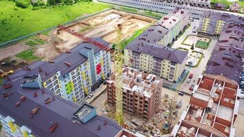 Construction site of a modern district in the city. Colorful urban buildings in a new microdistrict. Building with a bird's eyes. video