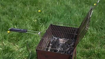 Brazier in nature at summer day. Charcoals in brazier for grilling food. Cooking barbeque on brazier. Prepare grilling charcoal heat for roasting meat. Concept of picnic with barbecue. video