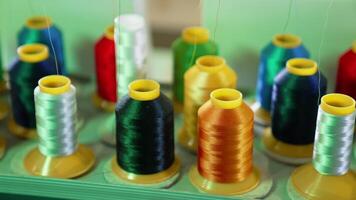 Bright threads in spools for tailor. Colorful spools with threads for sewing industry. Different colors of threads on the table. Handicraft. video