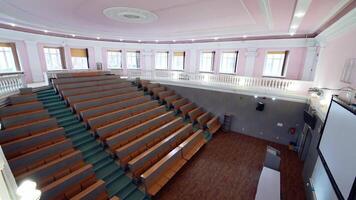 Large empty lecture hall. Modern auditorium with seats for students in the university. Light educational room with a white board in the centre. video
