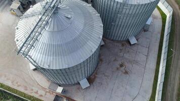 Metal grain elevator for storage crop. Modern silo. Large aluminum container. Orbital . Aerial top view. video