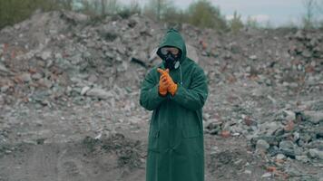 Portrait of a human in hazmat suit and respirator. Man in a protective suit and gas mask on the background of destroyed place. video
