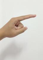 Close up Asian female 15 20 age hand pointing with index finger touching or pressing, sign arm and hand isolated on a white background copy space symbol language photo