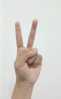 Closeup Asian female hand in scissors gesture, number two, victorious gesture, sign finger arm and hand isolated on a white background copy space symbol photo