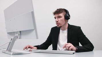 Technical support operator working with a headset in the office, speaking with a customer. White background, advertising video