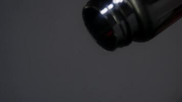 blurring and distortion. stack of pills is poured out one by one from top of bottle. clouded consciousness of patient with fever. Slow motion. Close up. Studio shot. video