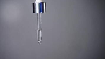 Employing medical pipette, precise quantity of medicinal drops is determined for ocular or aural administration, against backdrop of white. video