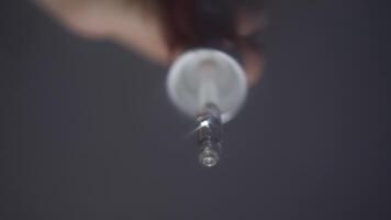 Drops of eye medicine are dripped directly into the eyes from a pipette, which makes the vision blurry. POV. Close up. Studio shot video