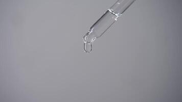 Using a medical pipette, an exact dose of medicinal drops is measured for the eyes or ears on a white background. Close up. Studio shot. video