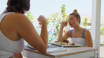 Two Sisters Have Lunch At The Resort After A Day At The Beach video