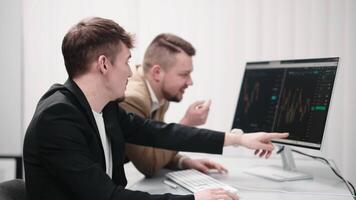 Two traders discussing cryptocurrency charts on a computer, analyzing financial risks and forecasting investment profits. Concept market research, investments, and making informed decisions video