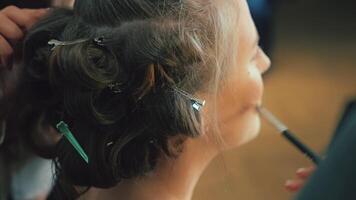 Foundation is applied to create flawless skin. Every stroke smooths and evens out the tone video