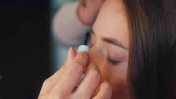 Lipstick is applied in front of a mirror. The lips gain vibrant color and volume video