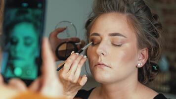 A flat lay of makeup tools and products sets the scene. She picks each item with care video