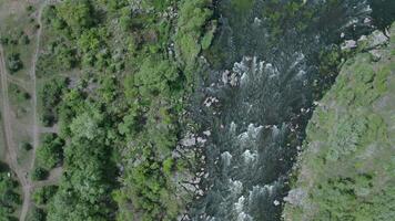 Aerial view of a turbulent stream scattered with large rocks. Trees and large stone boulders around. video