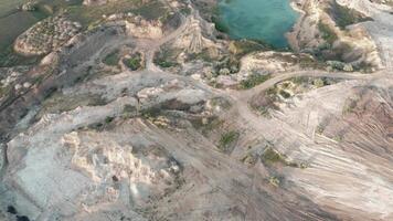 Aerial drone footage of a small rock quarry flooded into a small lake. Drone view of open cast mine. Turquoise background of the water in open pit. video