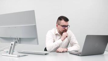 A businessman, young software developer working at a computer in an office. Concept innovative approach to managing online investments and business processes video