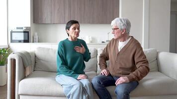 Stressed woman feel heart distress shortness of breath. Scared concerned husband calms wife on couch video
