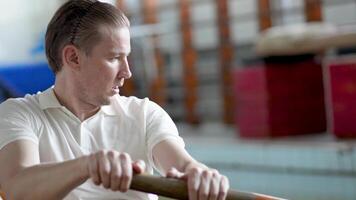 Determined tired captain rows vigorously, heavy breaths and focus on technique endurance training video