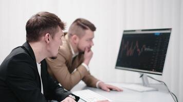 Two members of a finance team working together on a project during a brainstorming meeting. Concept collaborative teamwork, strategy planning, and small business startup growth video