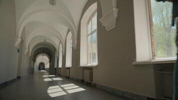 Empty corridor back view from behind student girl with yellow backpack follow going to class lesson in school university woman pupil female alone walking in academy college hall morning go to lecture video